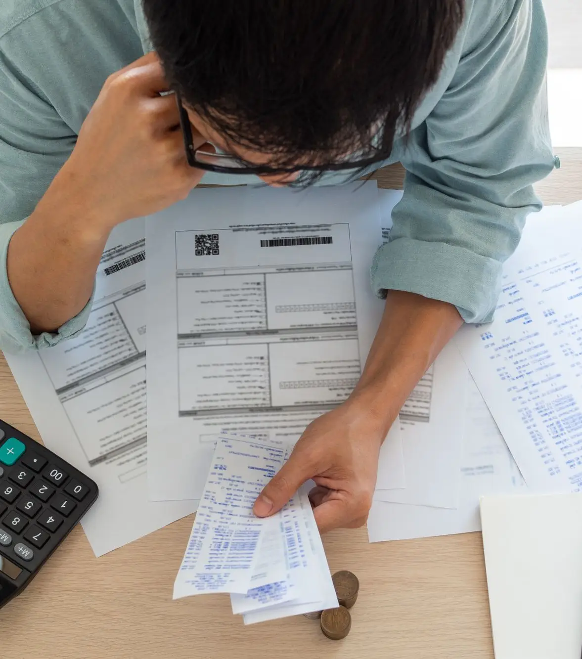 Man looking at many generated receipts